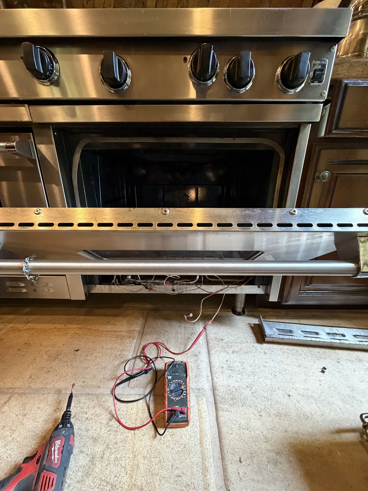 Oven opened up with test leads on the floor during an ApexPro repair