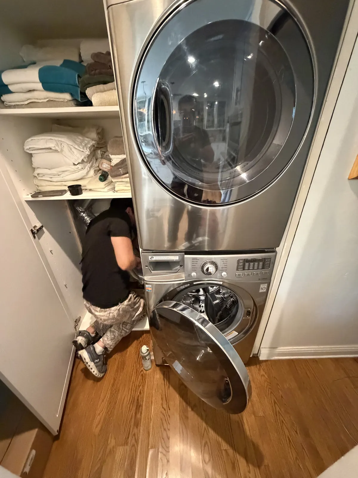 ApexPro technician at an open front-load washer in a Los Angeles home